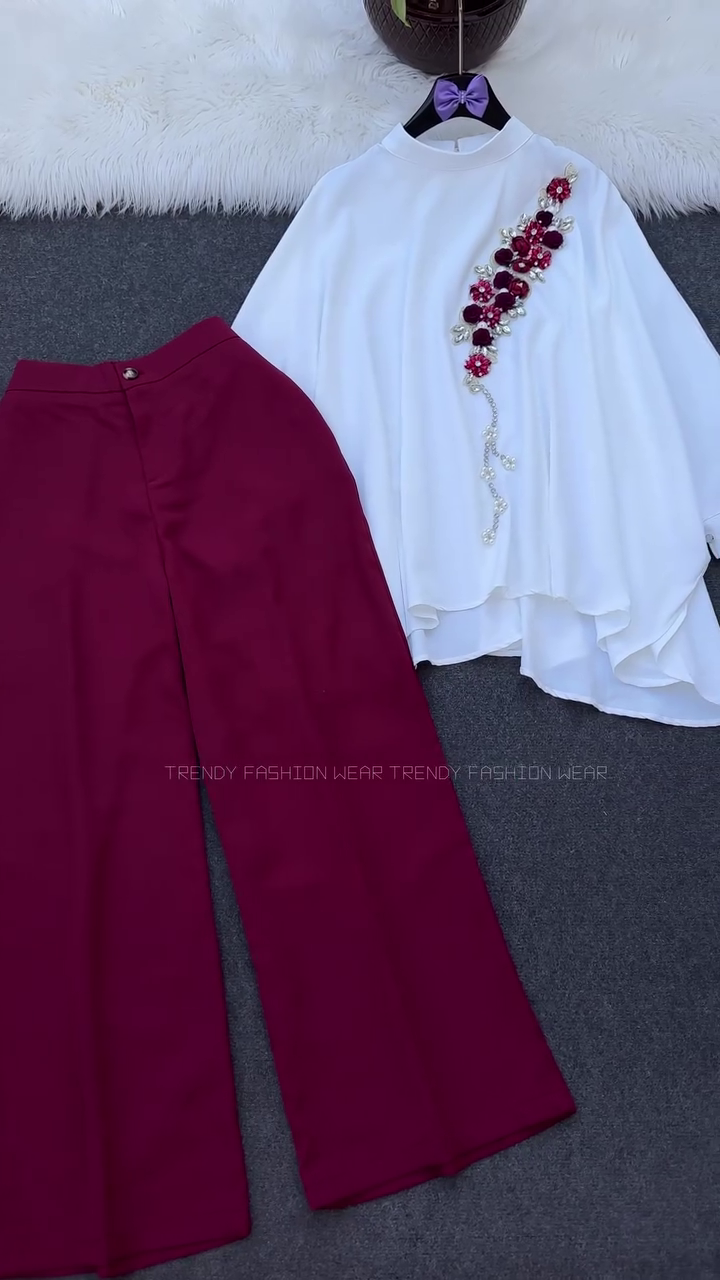 ✨ Elegant White Flowing Cape-Style Top With Floral Embellishment Paired With Rich Wine Wide-Leg Trousers for Sophisticated Occasion Wear